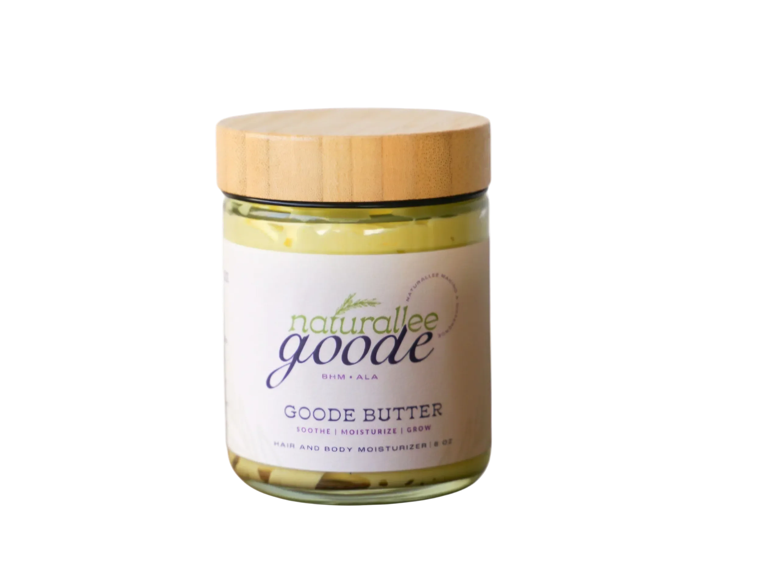 Jar of Goode Butter with a wooden lid on a white background